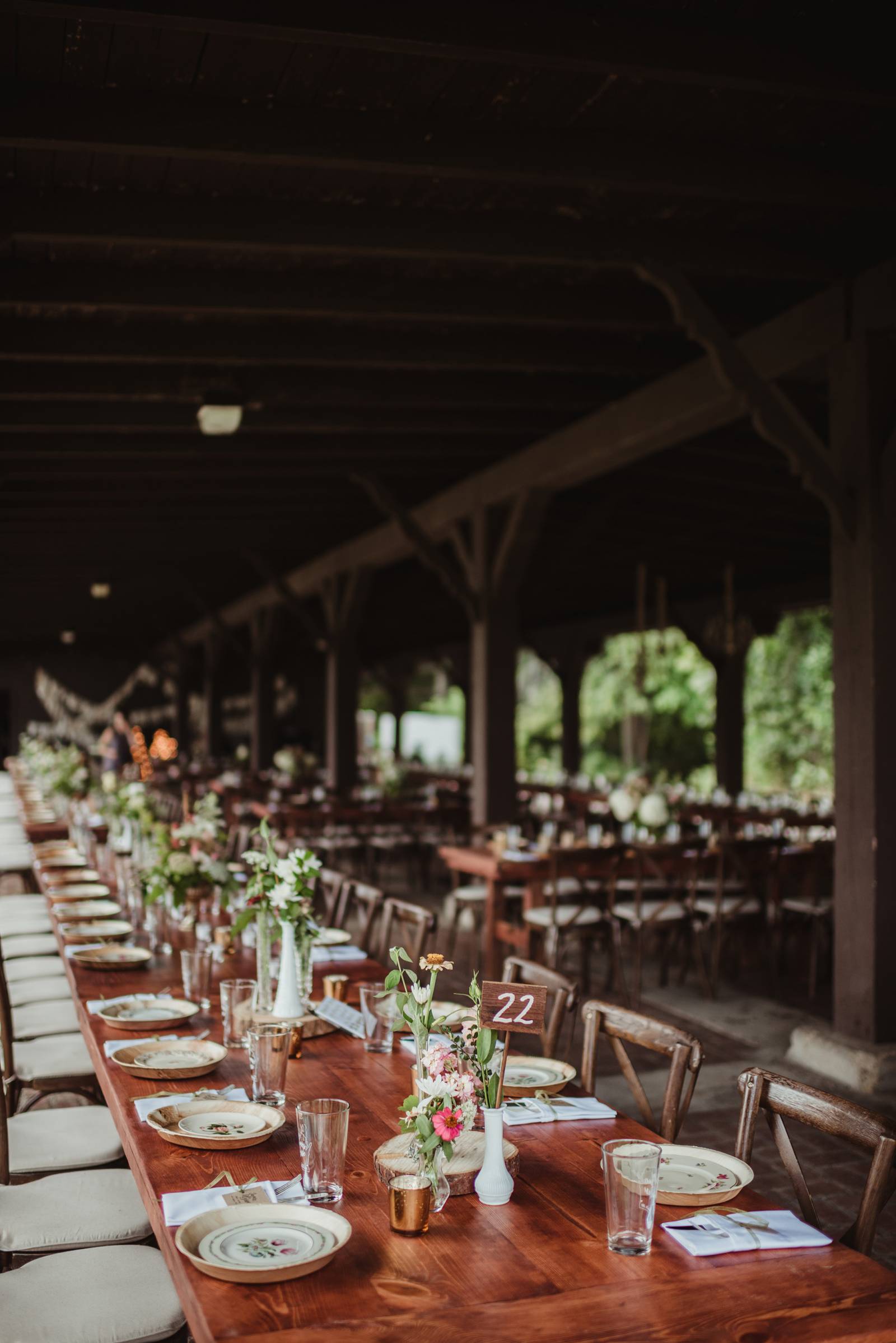 pavillion wedding reception table, centerpieces, wood table numbers, french country chairs