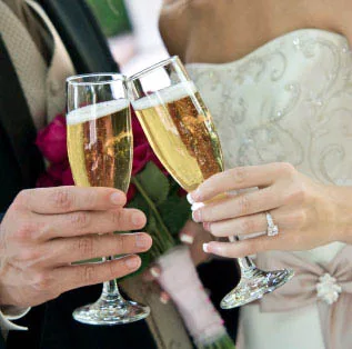 A newlywed couple toasts their celebration with glasses of premium bubbling sparkling wine crafted by Cambridge Winery near Madison.
