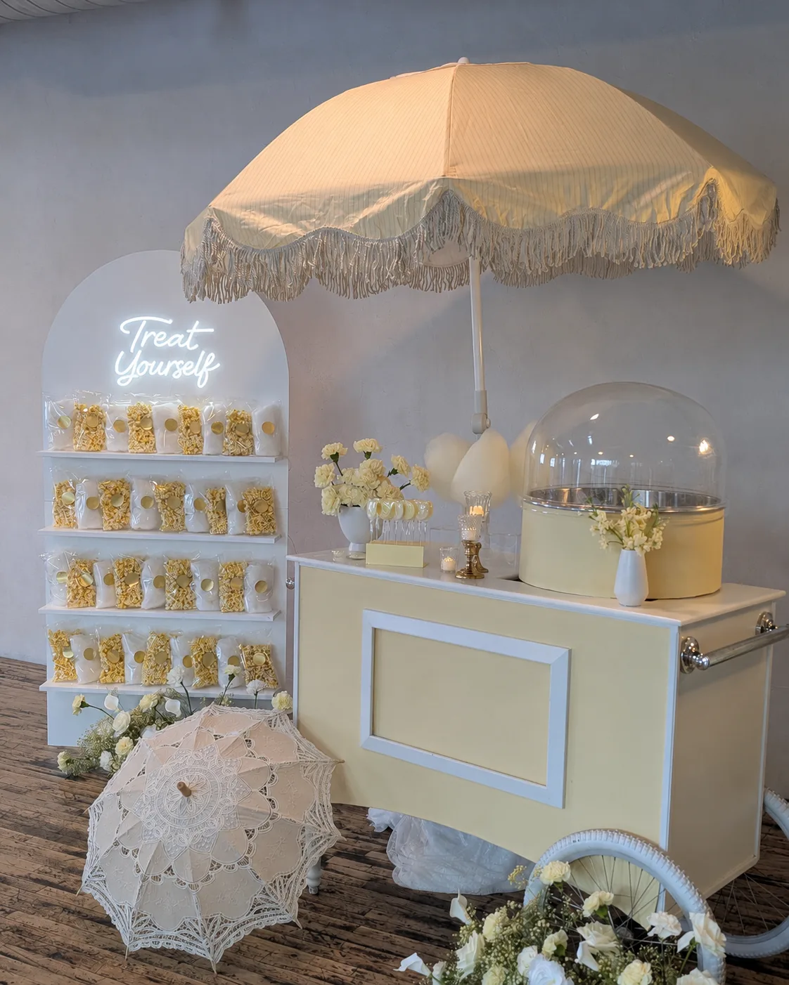 A yellow, spring-inspired cotton candy cart from Lily's Magical Treats.