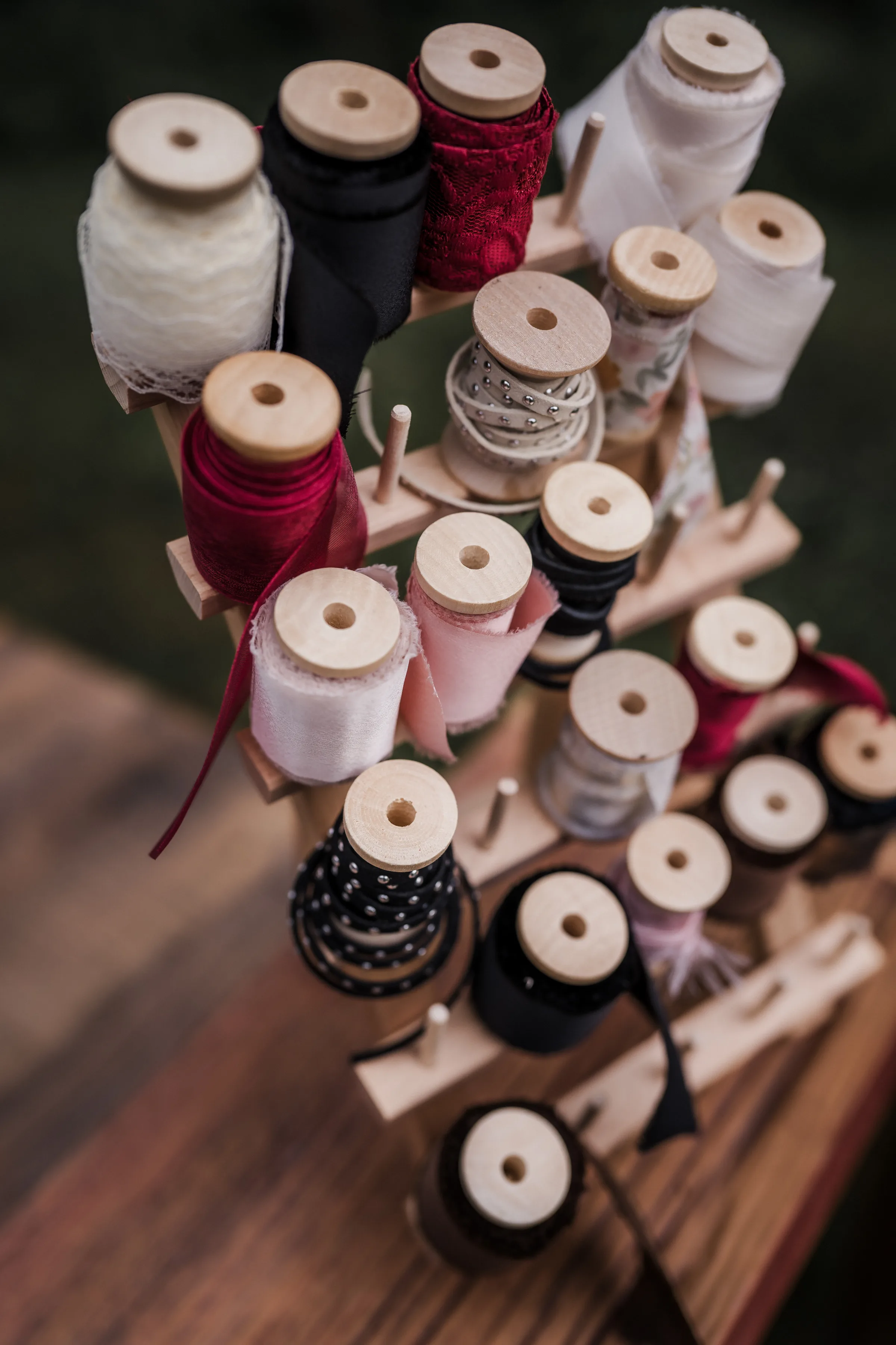 a detail photo of spools of threads and ribbons to customize hats at a modern cowboy wedding