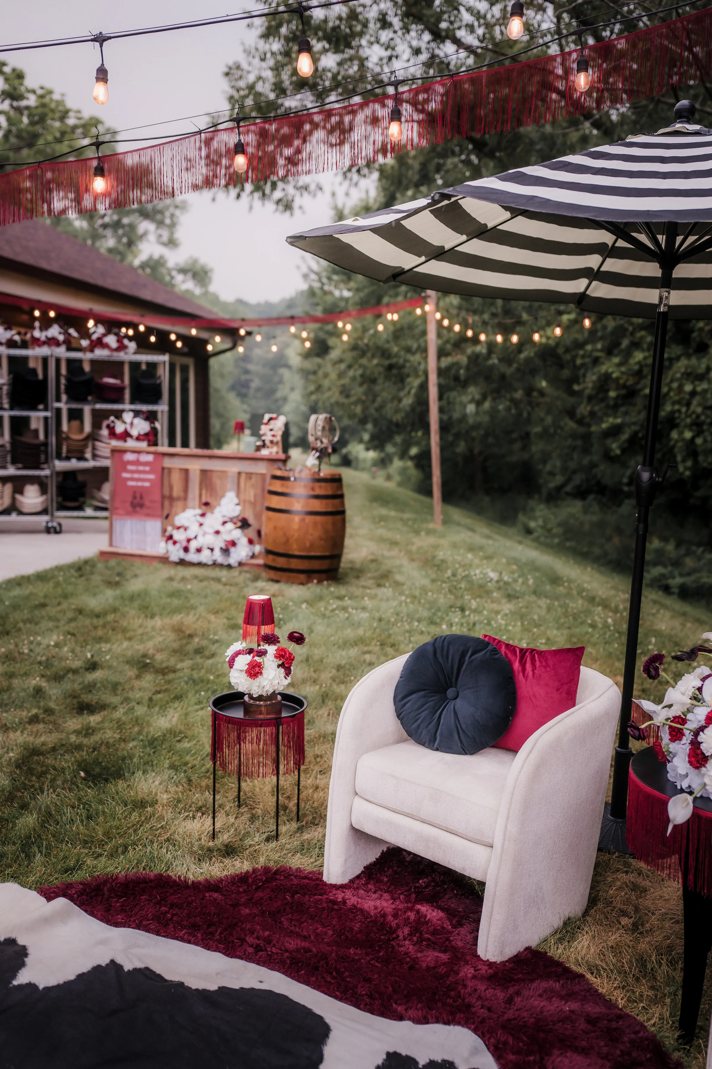 cozy lounge furniture from Event Essentials with black and white pillows, an end table, and rugs from Melody Rose Designs