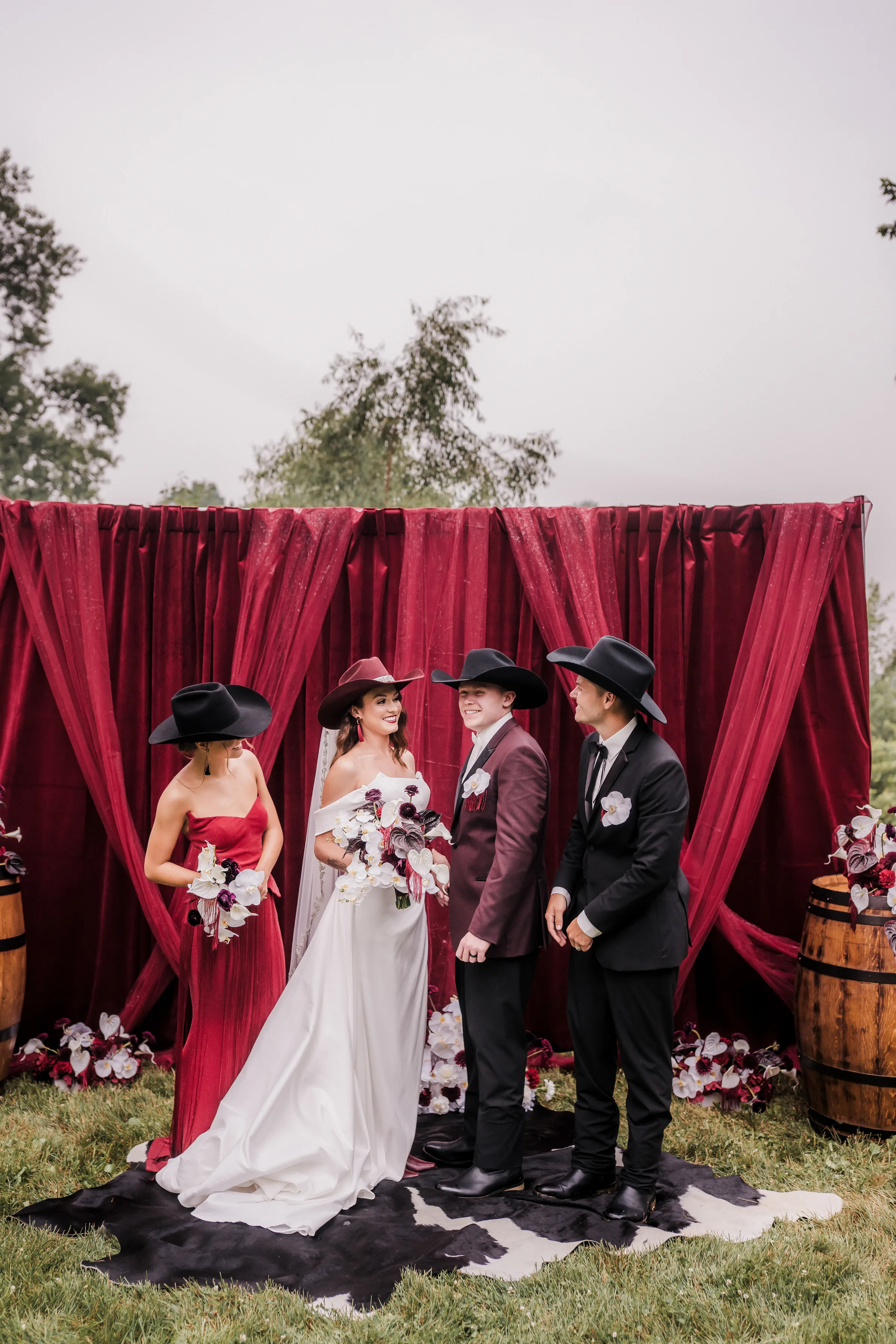 a couple stands with their maid of honor and best man at a modern cowboy wedding editorial
