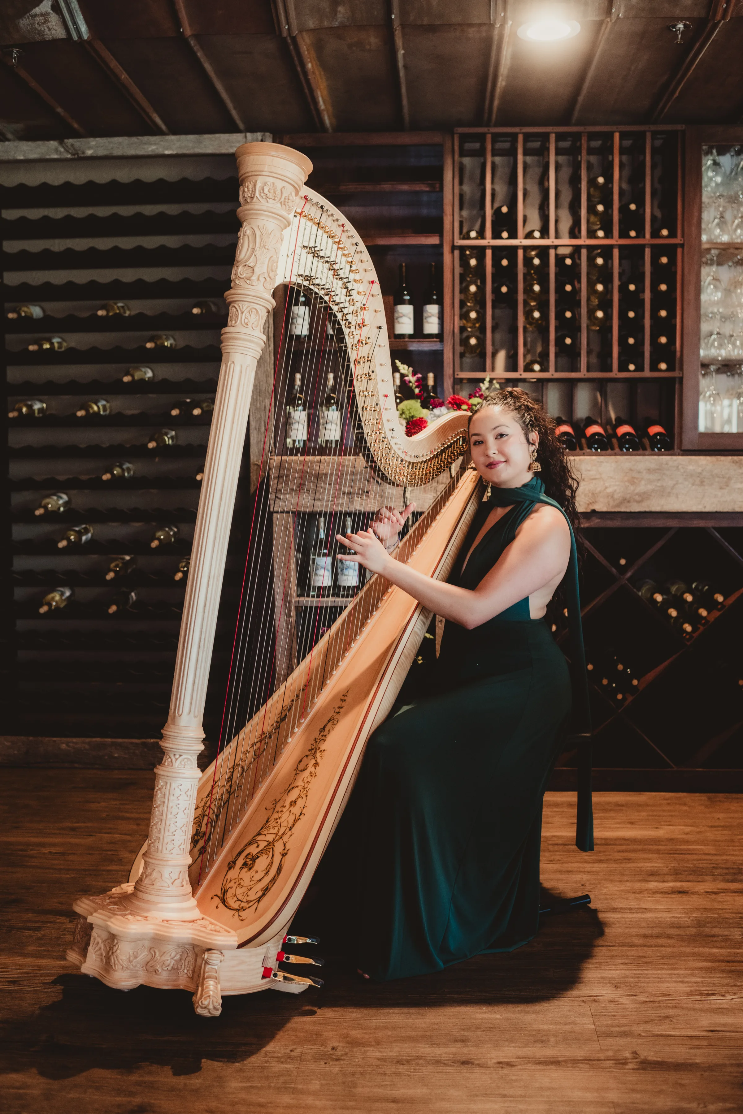 Bella the Harpist plays the harp in front of Vennebu Hill's wine cellar