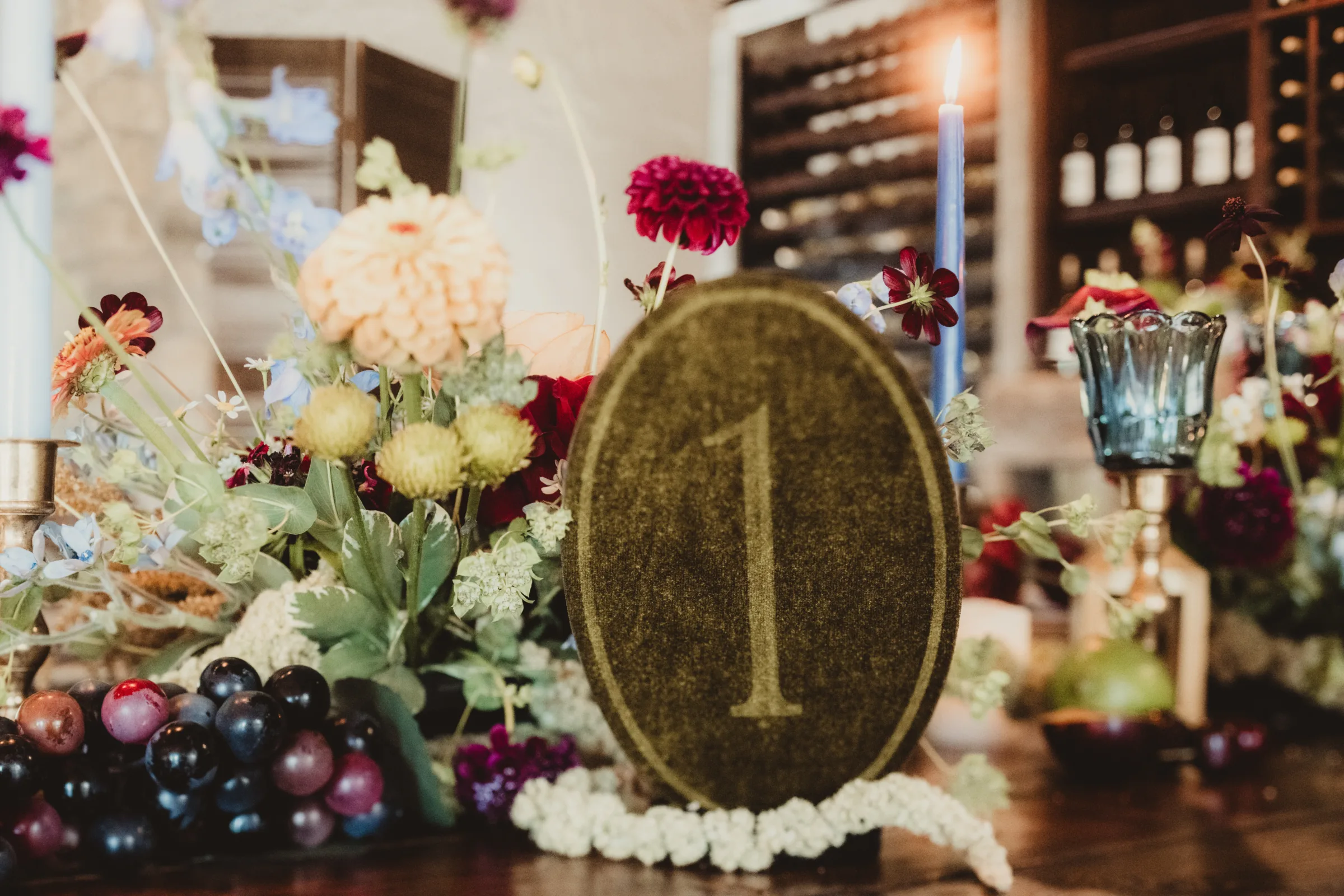 a close-up of textured olive table number, contour cut into an oval