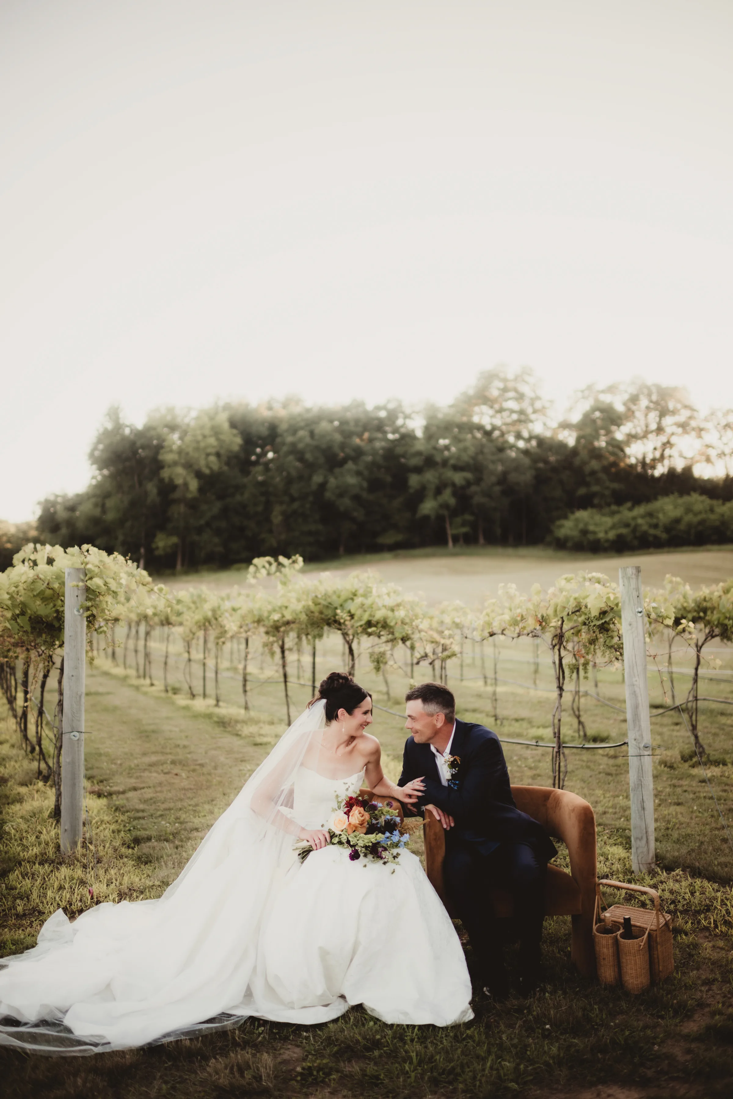 the models sit in Vennebu Vineyard, smiling at one another
