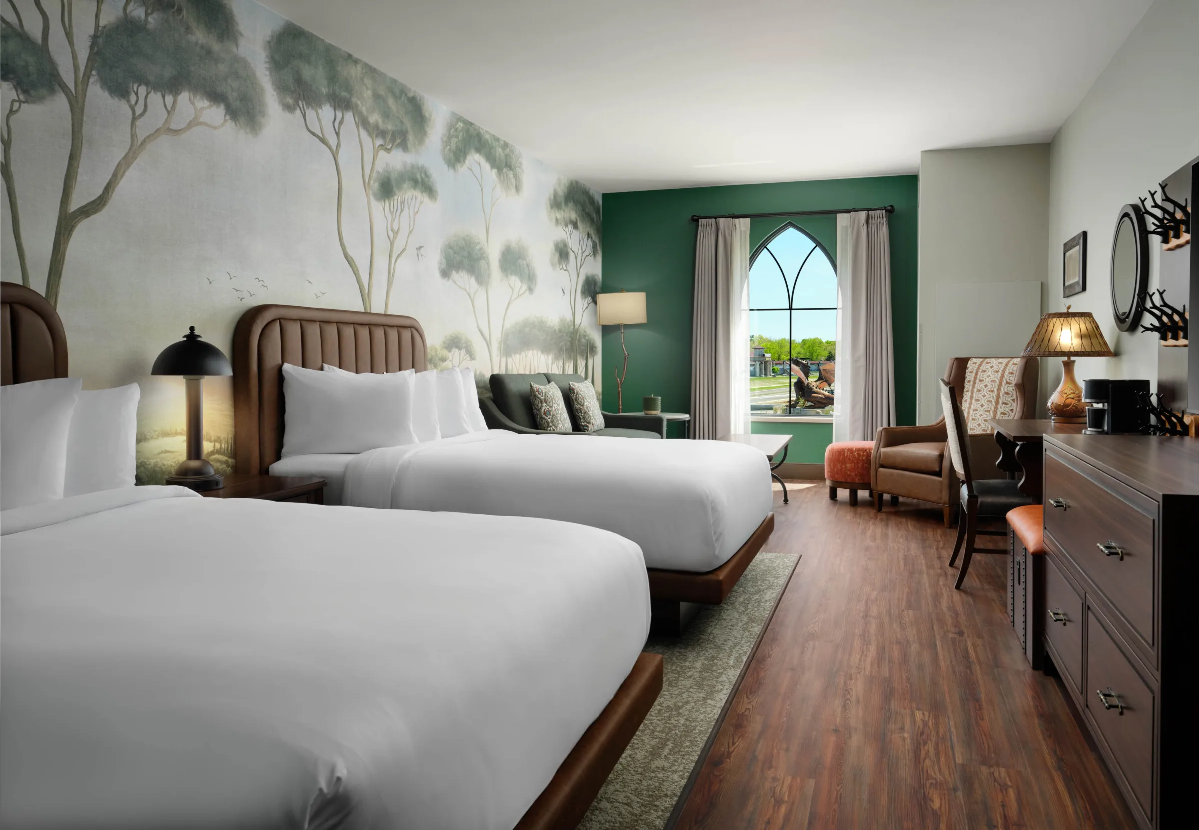 On-site wedding guest accommodations at Dellshire Resort, a luxury Wisconsin Dells hotel, featuring a double queen room with nature mural wallpaper and wood floors.