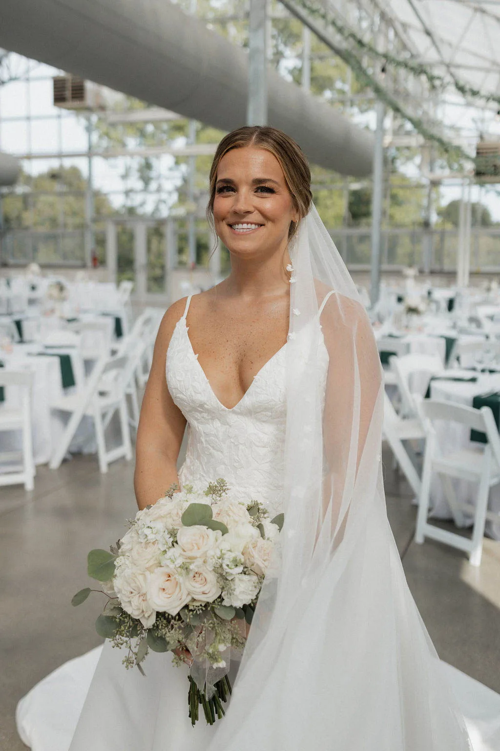 Bride wearing a classic sheer wedding veil and a soft glam makeup look by JJ Bridal Artistry.